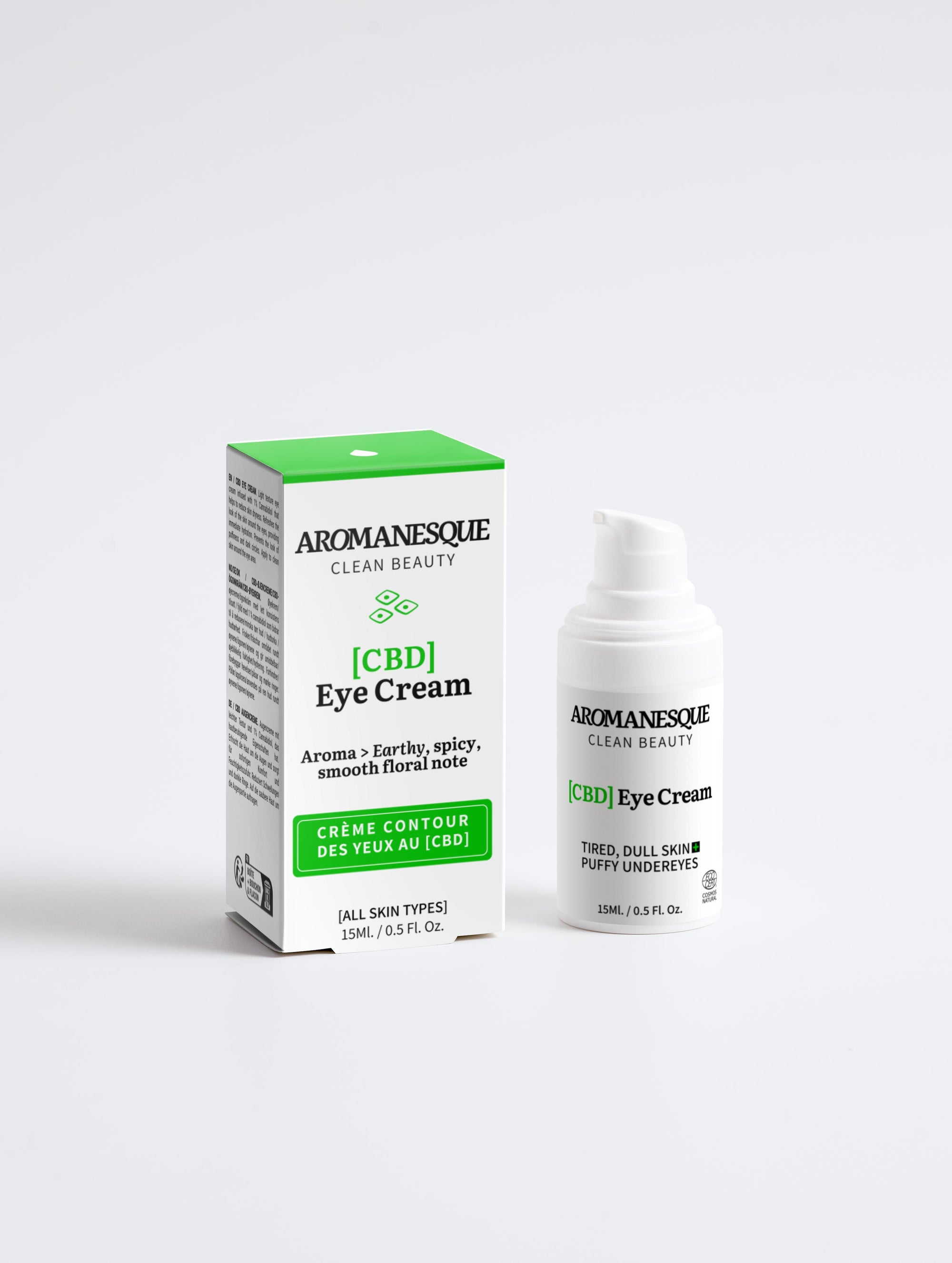 A package and container of Aromanesque Calming CBD Eye Cream, with the product visible through a clear window on the box. The packaging is primarily white and green with text and branding.